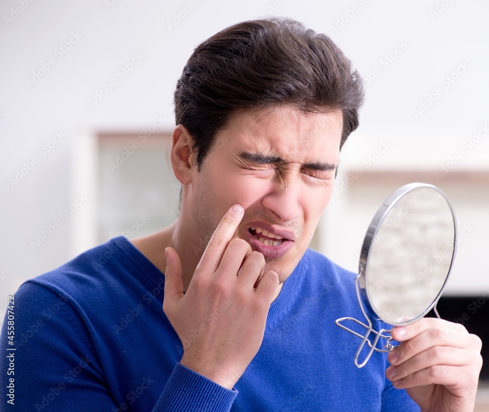Man panicking because of pimples on the skin Man panicking because of pimples on the skin