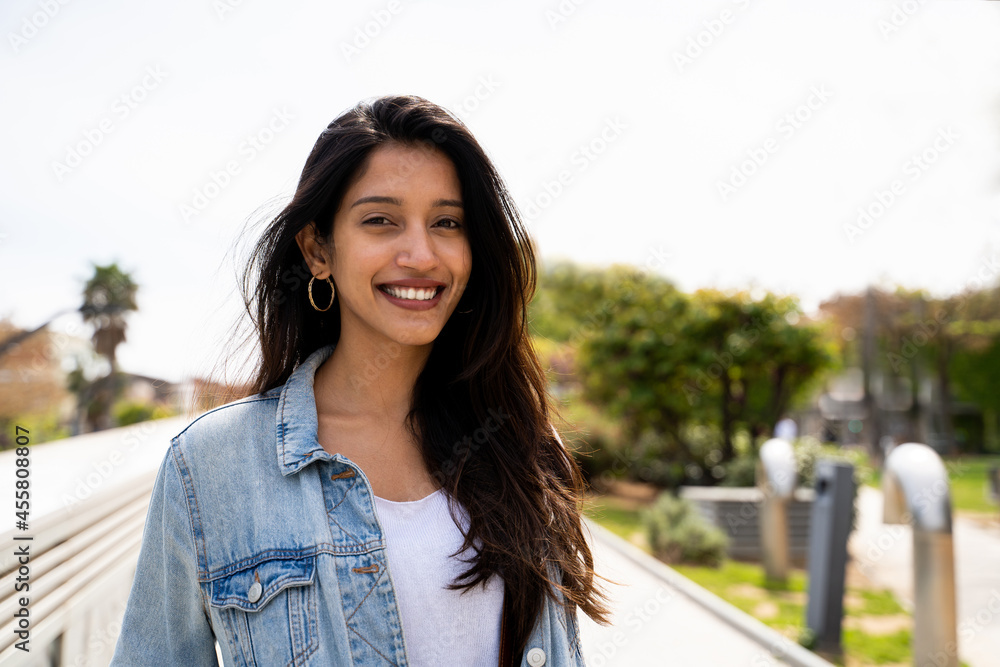 Portrait of happy young woman outdoors looking at camera Portrait of happy young woman outdoors looking at camera