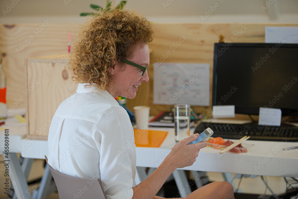 Portrait of woman using smart phone and smiling Portrait of woman using smart phone and smiling