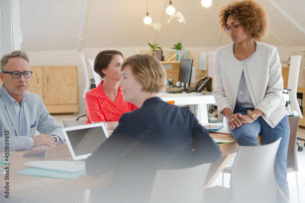 Office workers having meeting at desk Office workers having meeting at desk