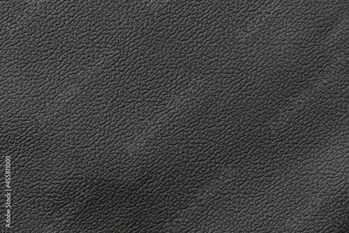 Texture of black genuine leather close-up, cowhide. For your background, copy space