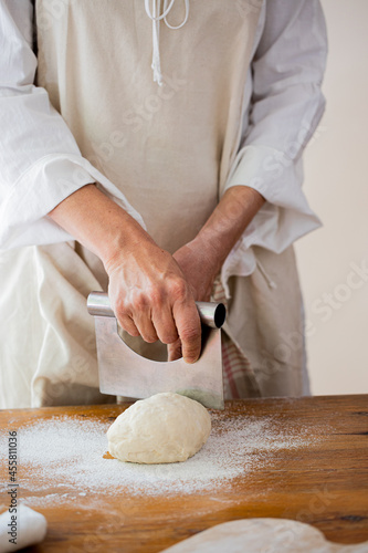Woman kneading dough to make bagels photo