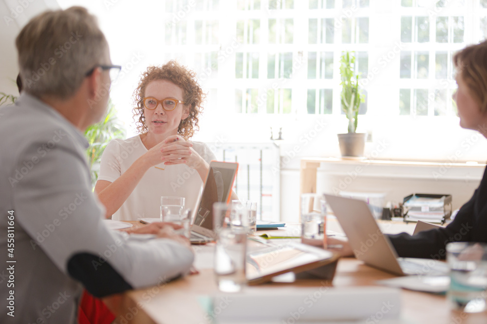 Office workers having meeting at desk Office workers having meeting at desk