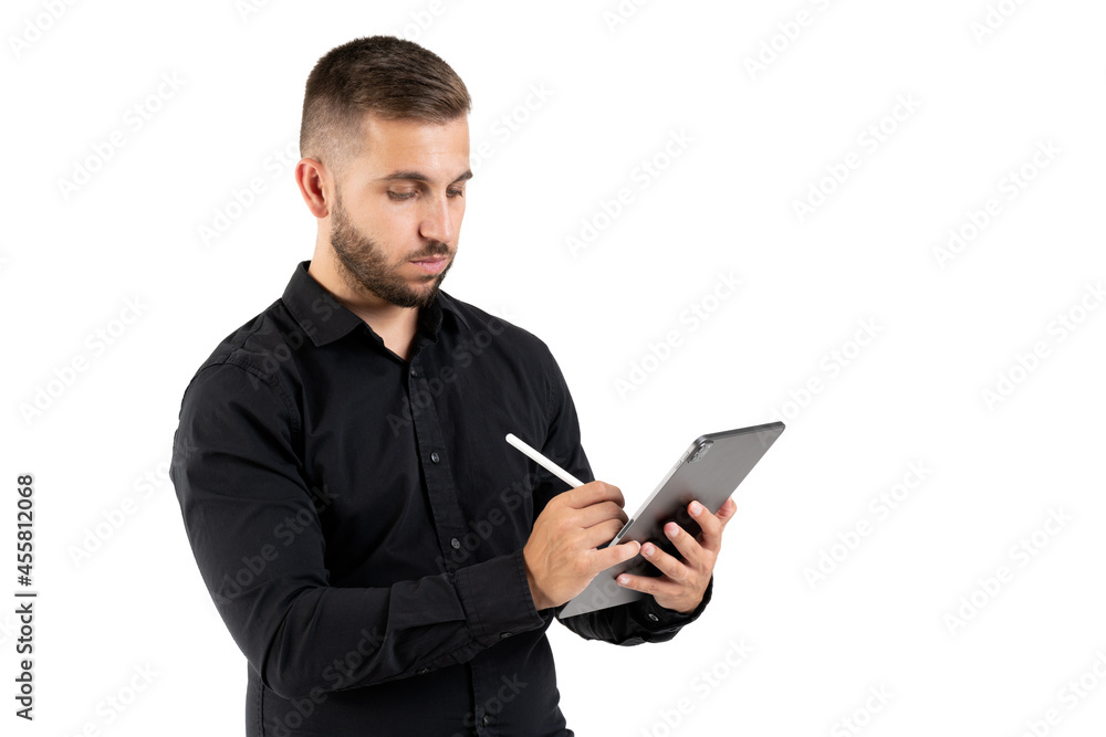 Young man with a black shirt taking notes on a grey tablet on a white background Young man with a black shirt taking notes on a grey tablet on a white background
