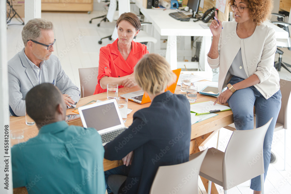 Office workers having meeting at desk Office workers having meeting at desk