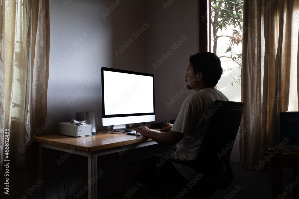 Man sitting infront of a computer, working from home. Man sitting infront of a computer, working from home.