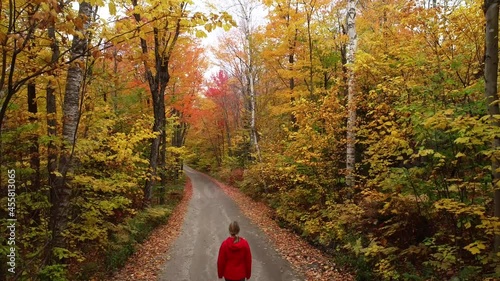 Woman walking through fall foliage in New England