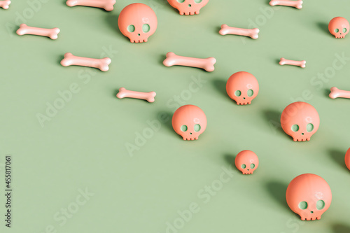 pink skulls and bone on green background photo