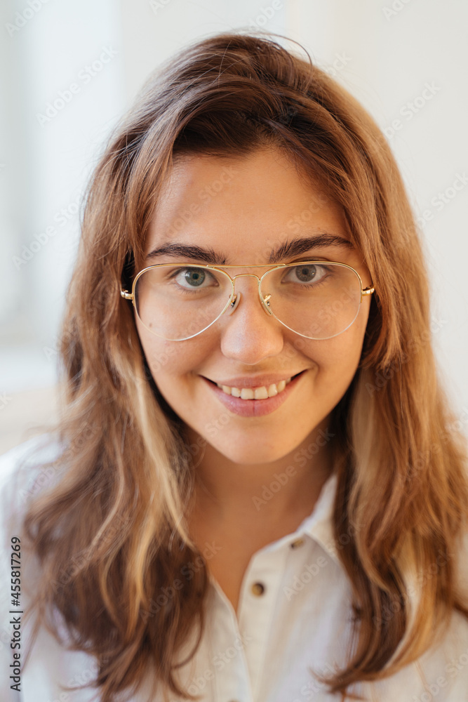 Smiling woman in glasses looking at camera Smiling woman in glasses looking at camera