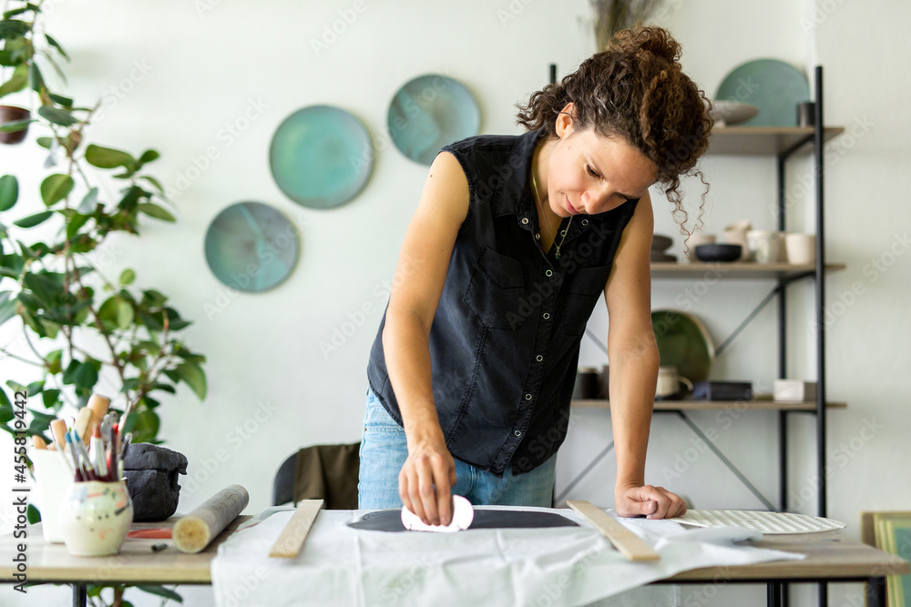 Handmade pottery workflow. Woman making ceramic plate. Handmade pottery workflow. Woman making ceramic plate.