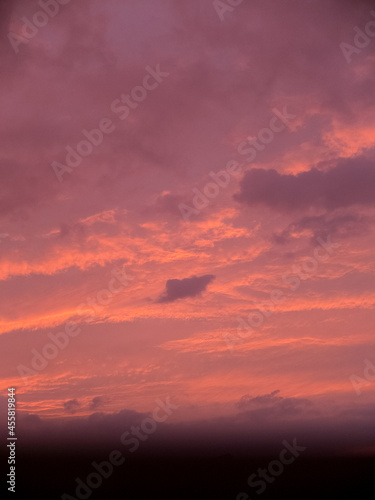 A cloudy sky during sunset with a blurred window frame. © Shirley