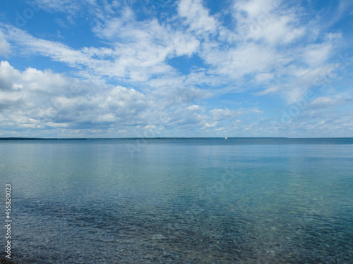 Summer by the beach of lake and sailboat.