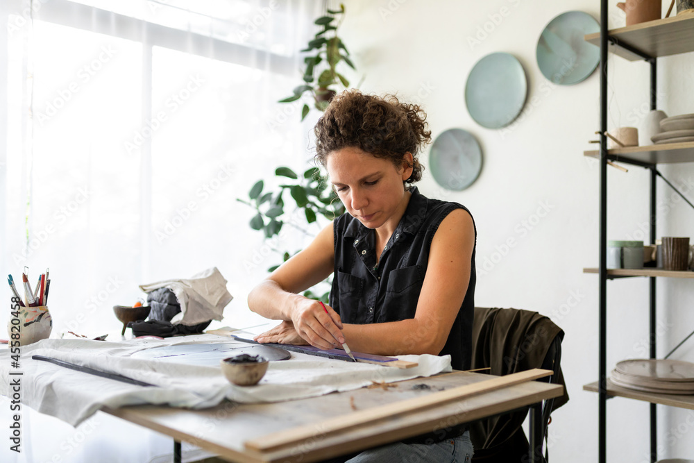 Handmade pottery workflow. Woman making ceramic plate. Handmade pottery workflow. Woman making ceramic plate.