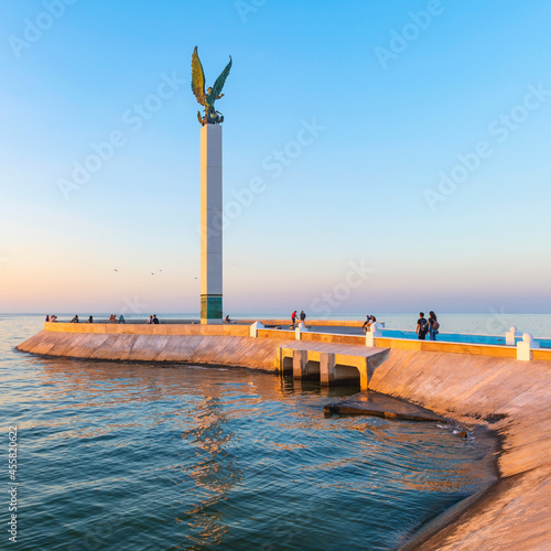 Pier of Campeche at sunset with waterfront promenade and people by the Gulf of Mexico. photo