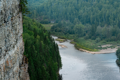 mountain river among wooded banks, view from the top of the cliff, the Usva river in the Perm Krai, Russia