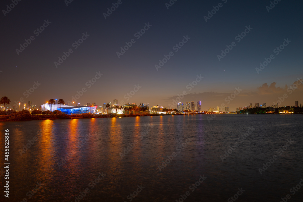 City of Miami Florida, sunset panorama with business and residential buildings and bridge on Biscayne Bay. Skyline night view.