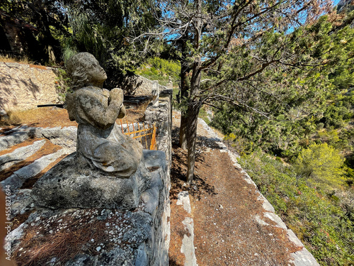 Broken and weathered angel statues guard an ancient cemetery by the abandoned village of Malo Grablje on the island of Hvar, Croatia. photo
