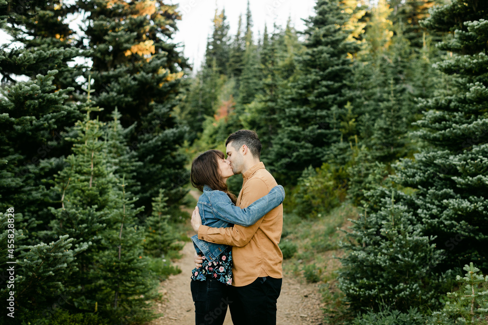 A Couple Share a Romantic Kiss in the Woods A Couple Share a Romantic Kiss in the Woods