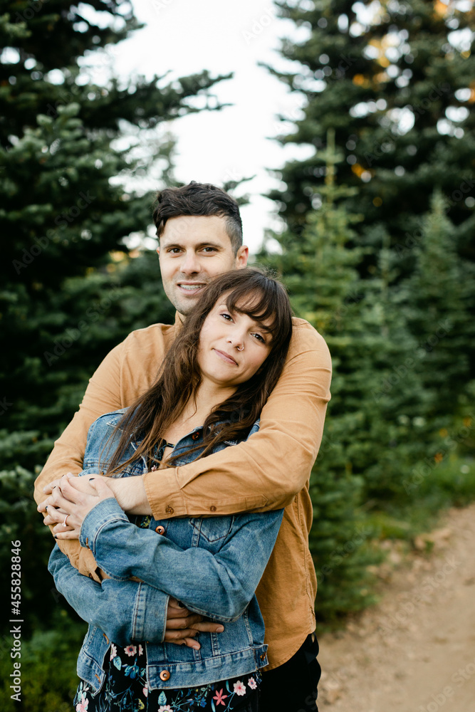 A Couple Affectionately Embraces in the Woods A Couple Affectionately Embraces in the Woods
