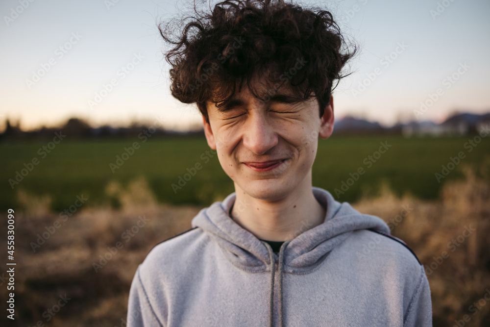 Squiting teenage boy outside. Squiting teenage boy outside.