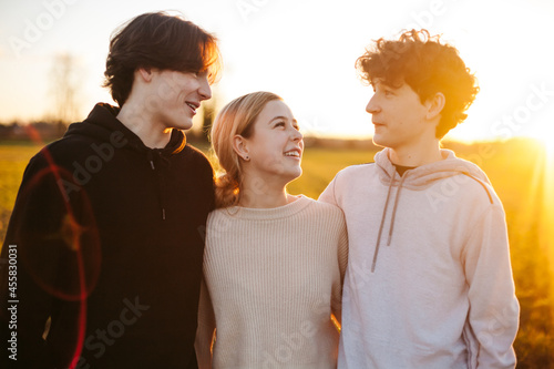 Three young adults / teens outside together. photo