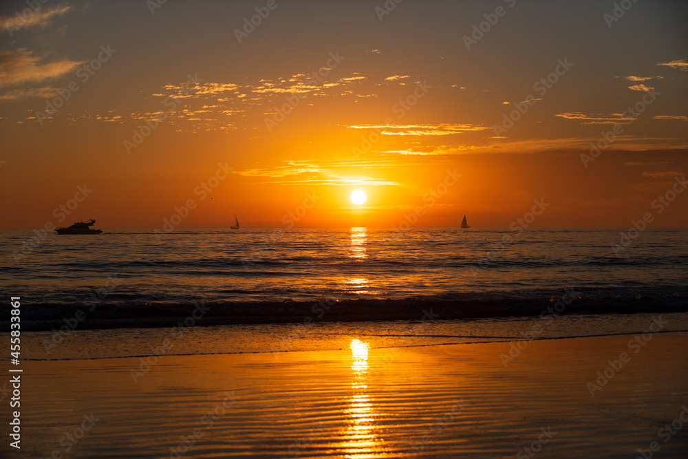 Fototapeta premium Sunset at the sea. Sunrise at beach. Colorful ocean beach sunrise.