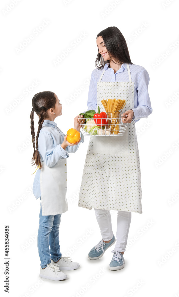 Young mother and daughter with fresh products on white background Young mother and daughter with fresh products on white background