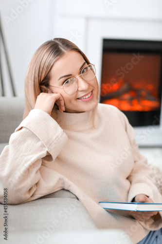 Smiling young woman in glas...