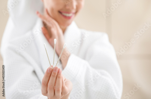 Young woman with cotton buds in bathroom