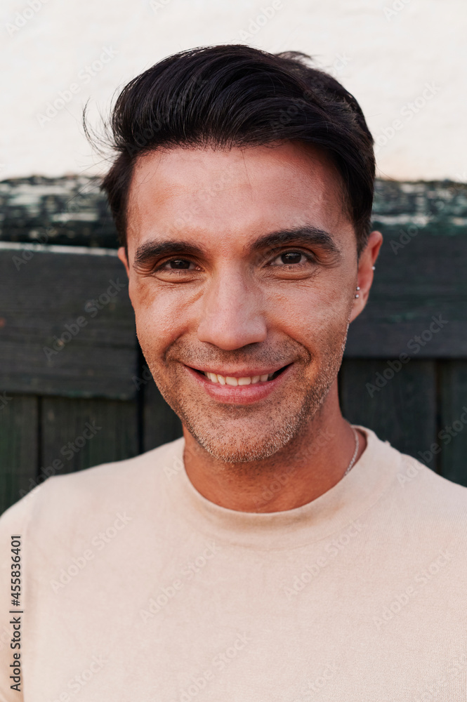 Smiling man standing outside in summer Smiling man standing outside in summer