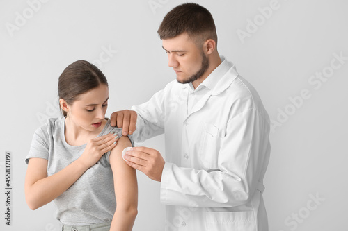 Doctor applying cotton pad ...