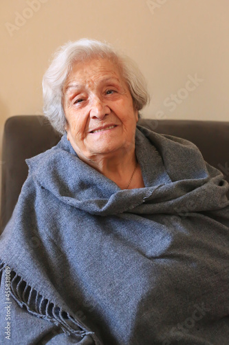 Portrait of a very elderly woman close-up. Positive ninety year old grandmother