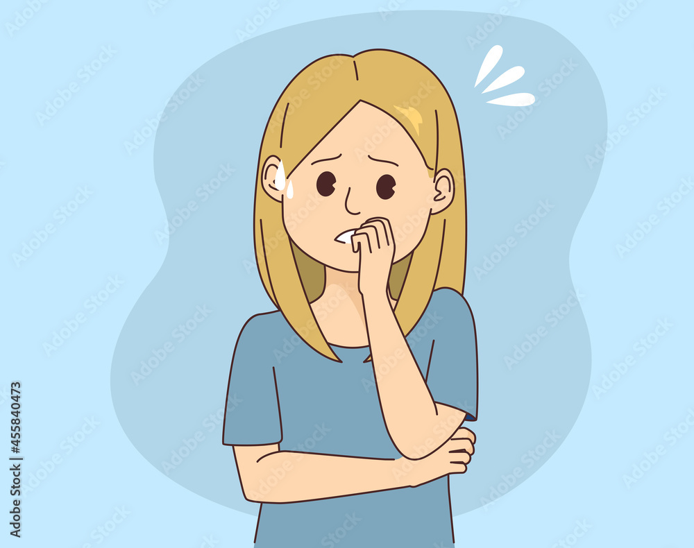 Young anxious worried woman shows stressed and nervous face expression with hands on mouth biting nails Young anxious worried woman shows stressed and nervous face expression with hands on mouth biting nails