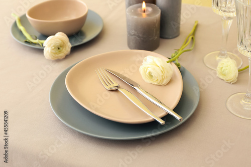 Stylish table setting and ranunculus flowers