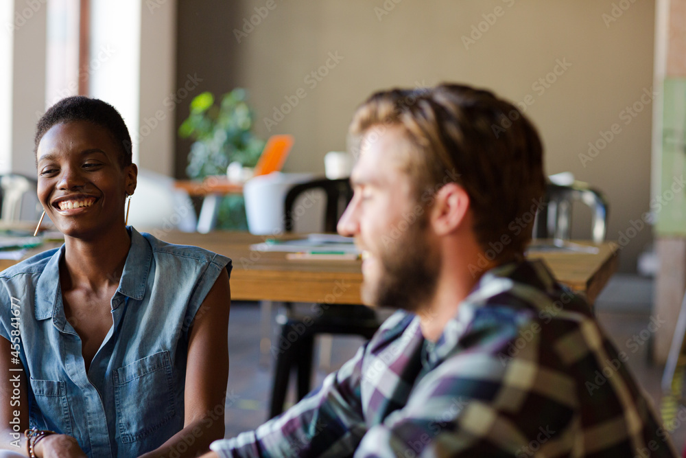 Smiling casual business people talking in office Smiling casual business people talking in office