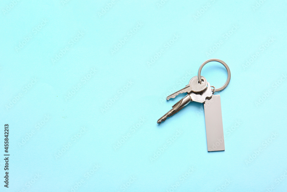 Keys with stylish keychain on color background Keys with stylish keychain on color background