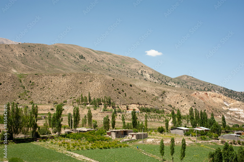Mountains with garden and village houses and a cloudy sky in mazandaran province, Iran Mountains with garden and village houses and a cloudy sky in mazandaran province, Iran