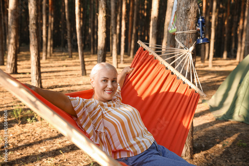 Mature woman in hammock at ...