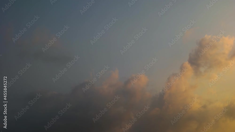 timelapse of cumulonimbus clouds at dusk against blue sky background timelapse of cumulonimbus clouds at dusk against blue sky background