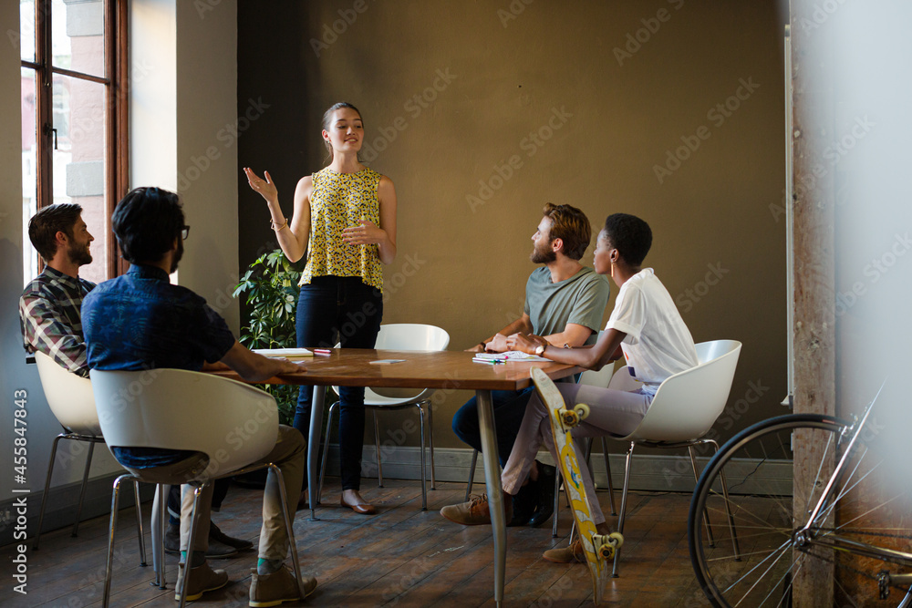 Casual business people meeting in circle in sunny office Casual business people meeting in circle in sunny office