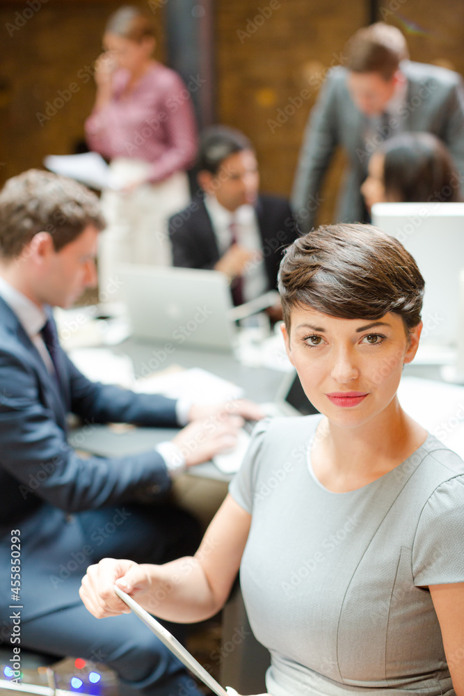 Smiling businesswoman holding tablet computer Smiling businesswoman holding tablet computer