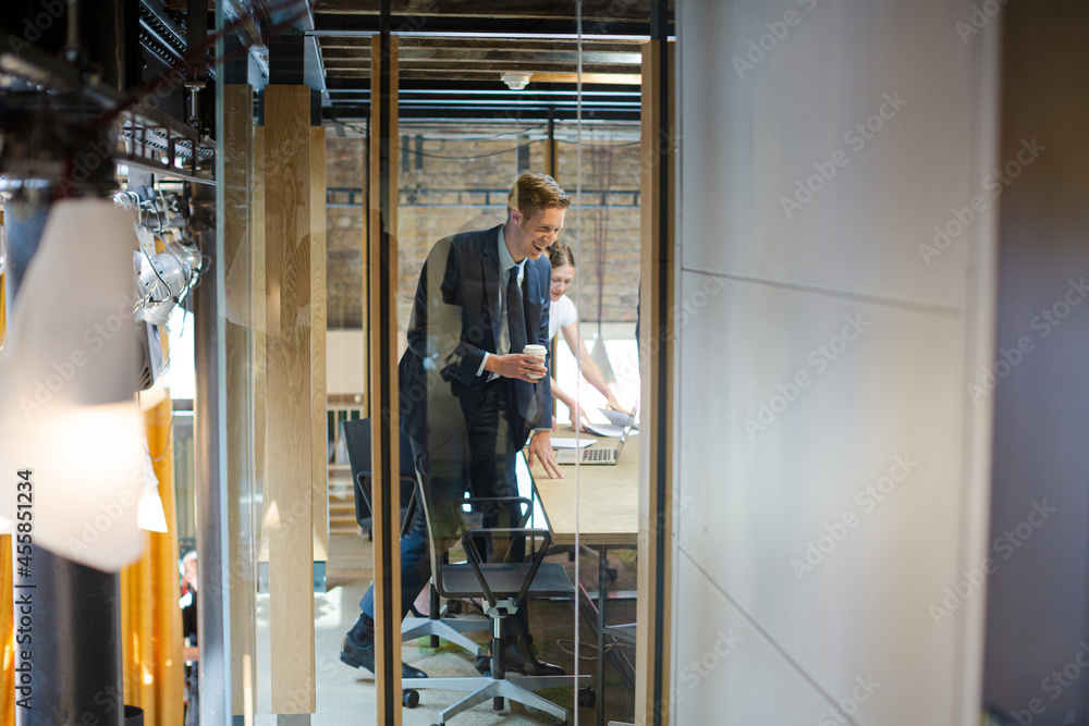 Laughing businessman in office