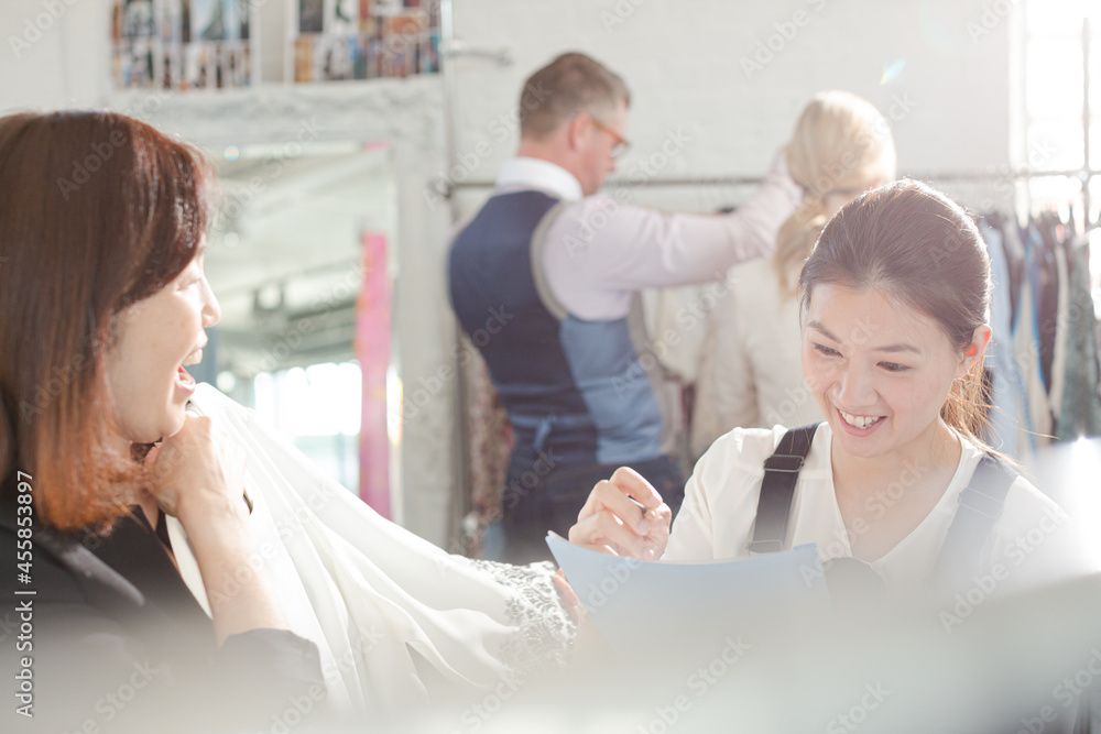 Fototapeta premium Fashion designers taking notes on clothing