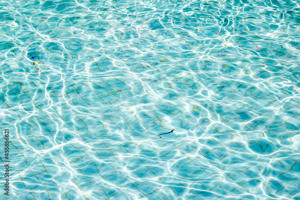 Close up of Swimming pool water 
 texture background Aquatic surface with waves backdrop. Top view.
