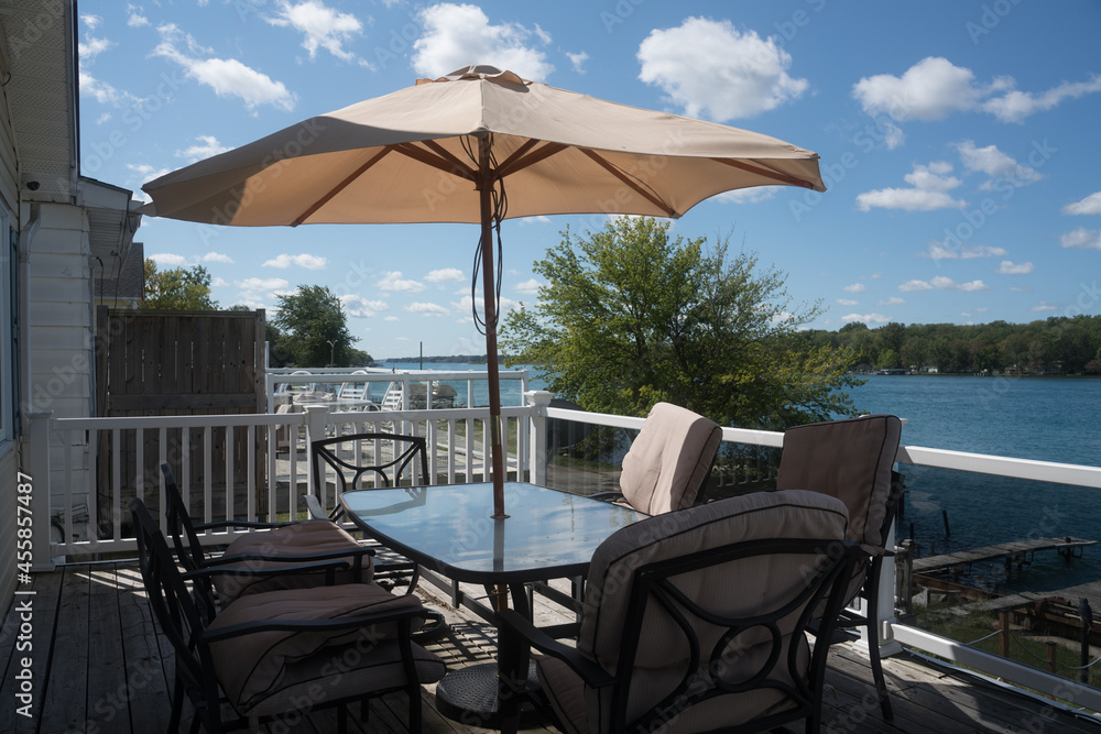 Outdoor patio dining table with waterfront view at a cottage