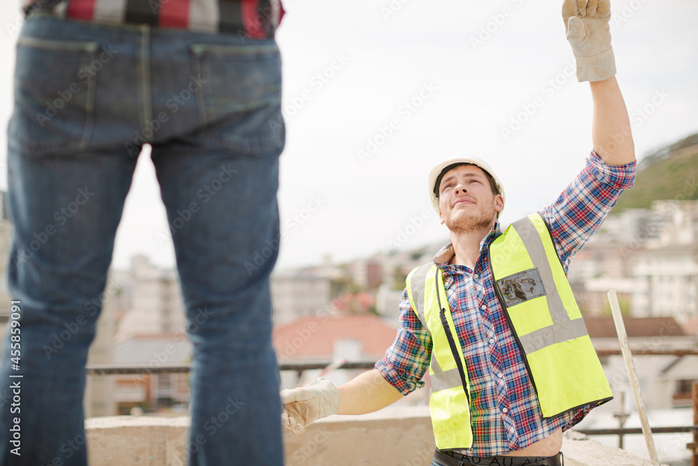 Construction workers lifting part at highrise construction site Construction workers lifting part at highrise construction site