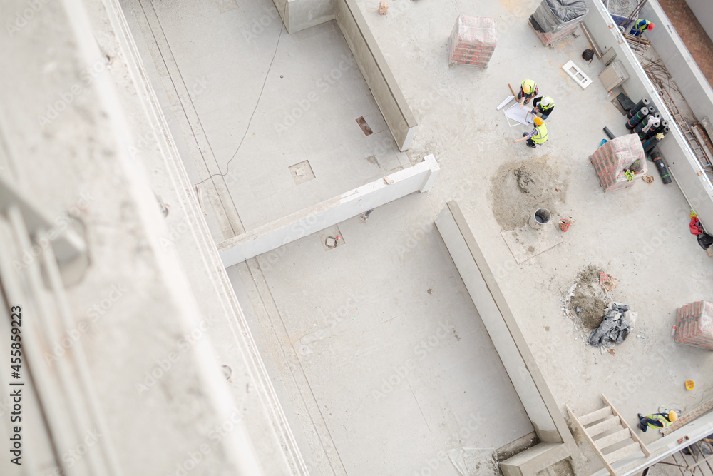 Overhead view of construction workers at construction site Overhead view of construction workers at construction site