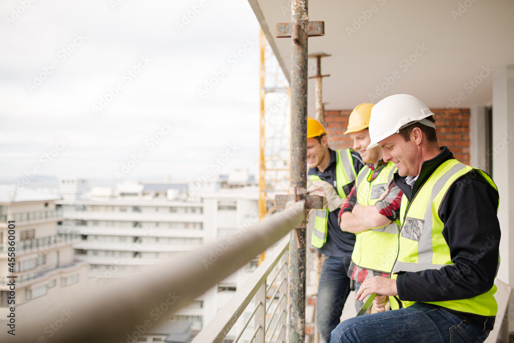 Construction workers talking at highrise construction site