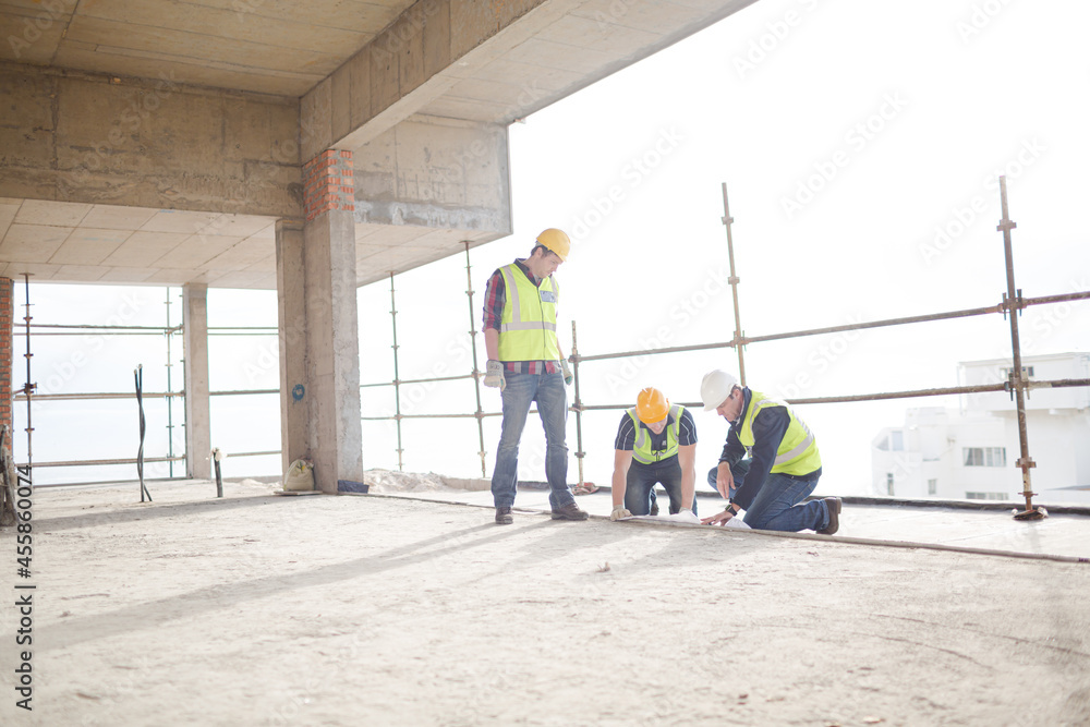 Construction workers working at highrise construction site