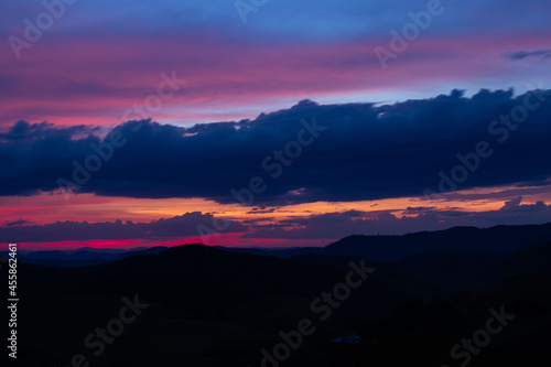 sunset, mountains, valleys, landscape, golden hour, orange sky.
blue and orange sky
